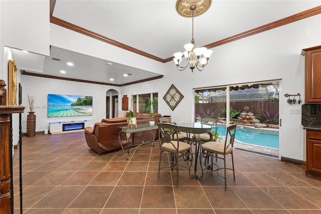 tiled dining area with an inviting chandelier and ornamental molding