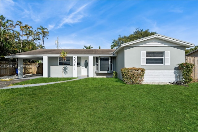 single story home featuring a carport and a front lawn