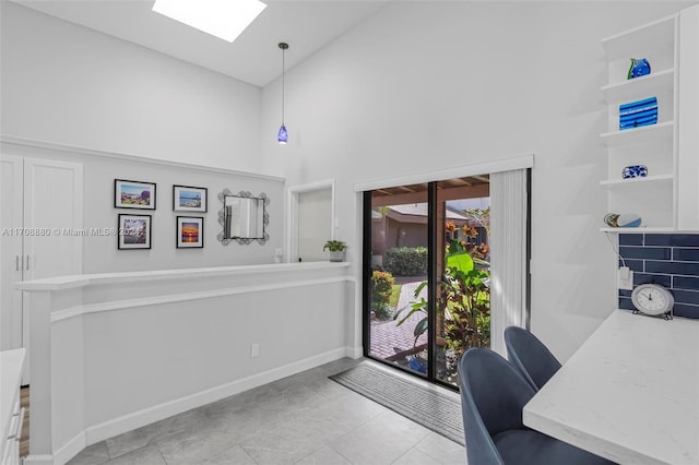 tiled office with a skylight and high vaulted ceiling