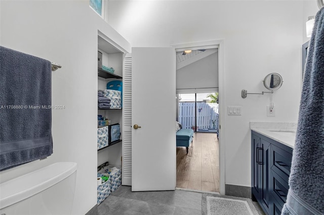 bathroom featuring vanity, lofted ceiling, and hardwood / wood-style flooring