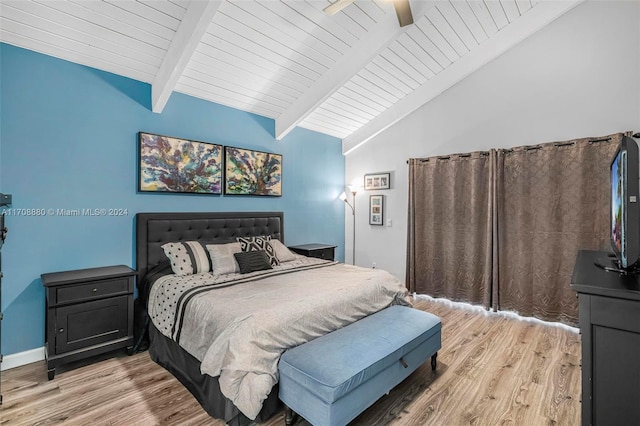 bedroom featuring vaulted ceiling with beams, ceiling fan, and light hardwood / wood-style floors