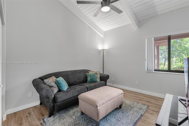 living room with lofted ceiling with beams, light hardwood / wood-style floors, ceiling fan, and wooden ceiling