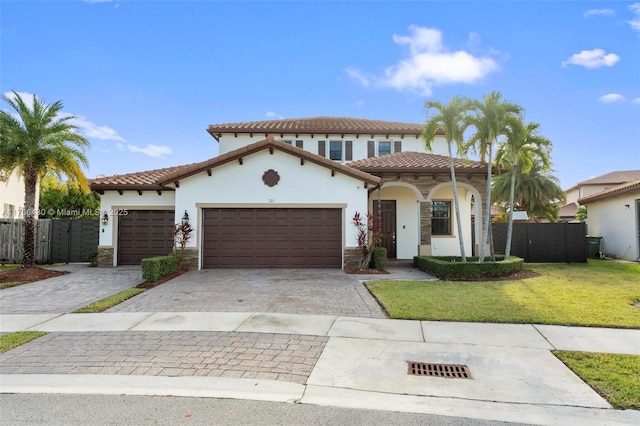 mediterranean / spanish-style house with a garage and a front yard