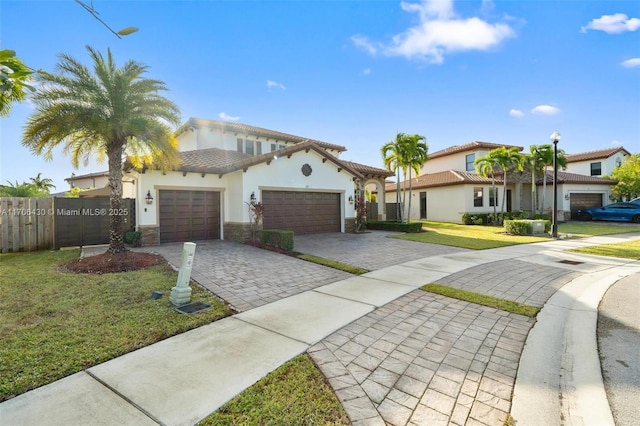 mediterranean / spanish-style home featuring a garage and a front lawn