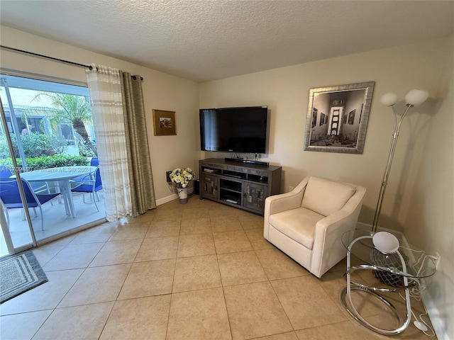 living room featuring light tile patterned floors and a textured ceiling