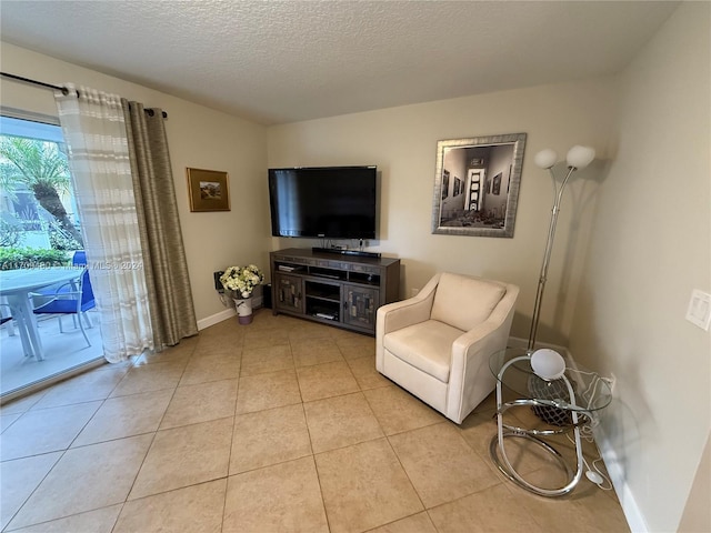 living area with light tile patterned floors and a textured ceiling