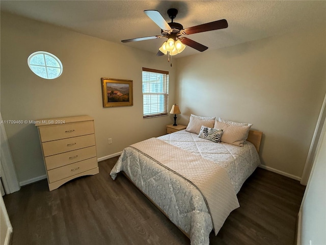 bedroom featuring a textured ceiling, dark hardwood / wood-style floors, and ceiling fan