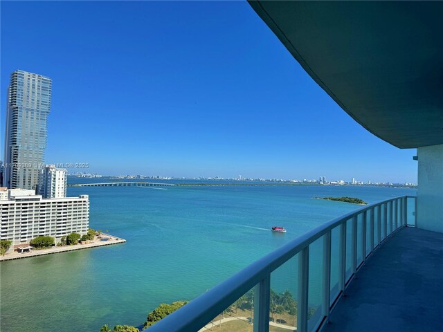 balcony featuring a water view