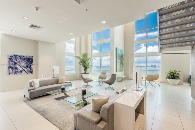 spare room featuring light carpet and expansive windows