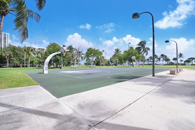 view of basketball court with a lawn