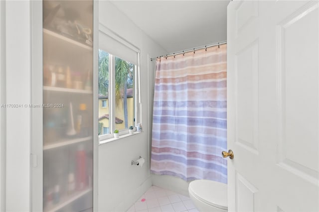 bathroom with tile patterned flooring and toilet