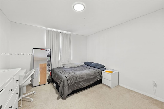 bedroom featuring light carpet