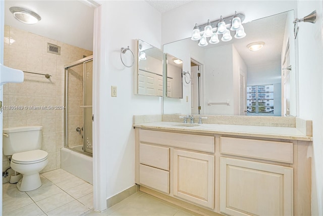 full bathroom featuring tile patterned flooring, vanity, toilet, and enclosed tub / shower combo