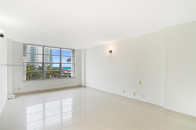 spare room featuring light tile patterned floors