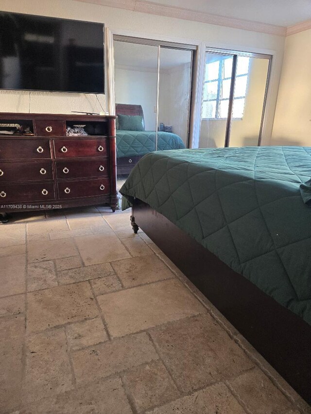 bedroom featuring crown molding and a textured ceiling