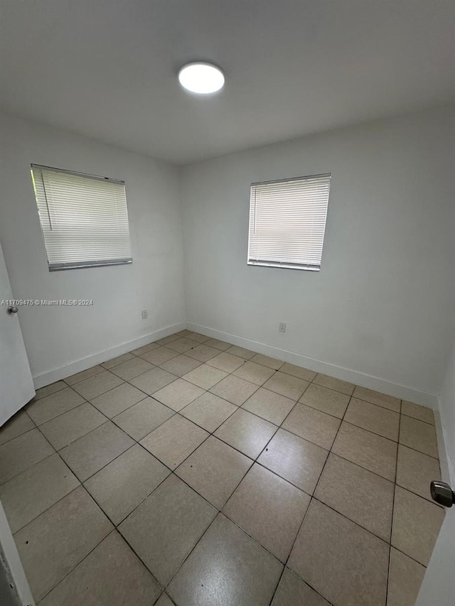 empty room with light tile patterned flooring