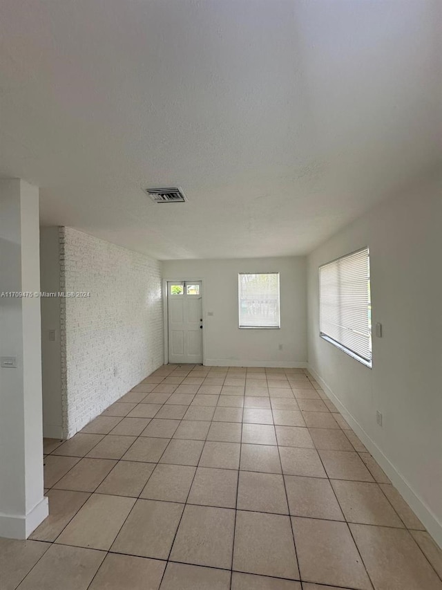 empty room with light tile patterned floors