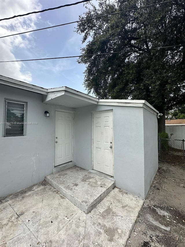 view of exterior entry featuring a patio