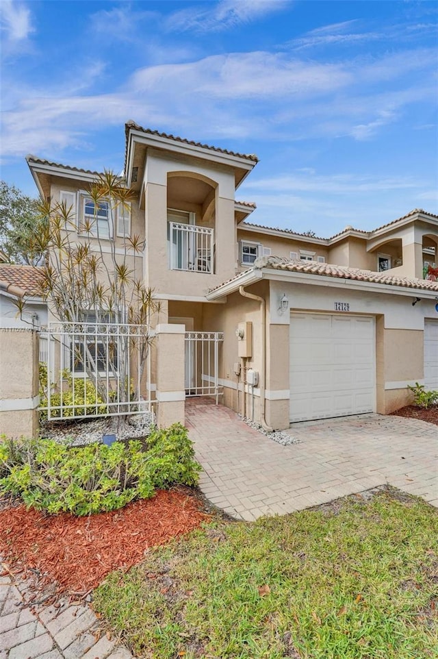 view of front of property with a balcony and a garage