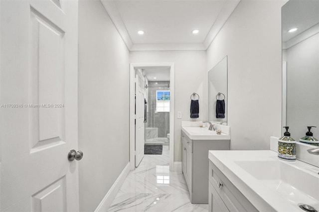 bathroom featuring vanity, toilet, a shower with door, and crown molding