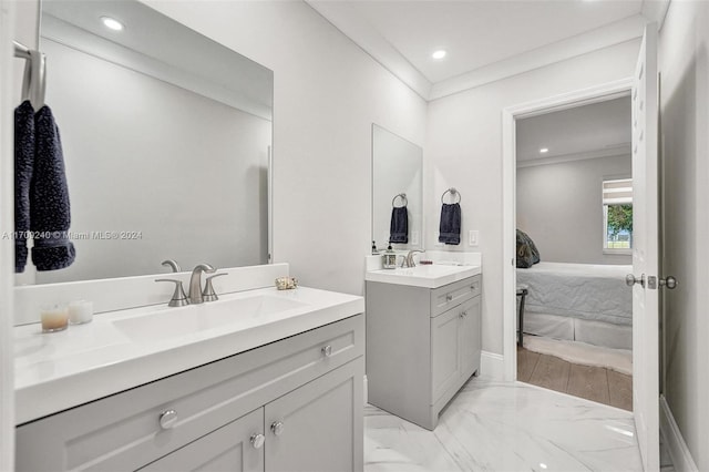 bathroom with crown molding and vanity