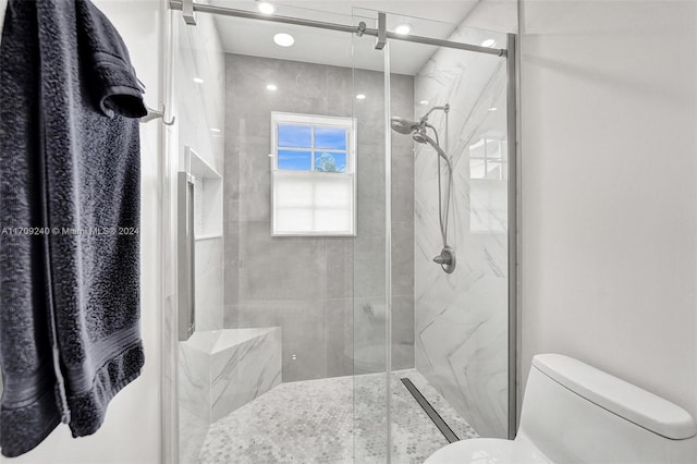 bathroom with an enclosed shower and toilet