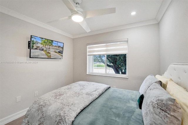 bedroom featuring ceiling fan, hardwood / wood-style floors, and ornamental molding