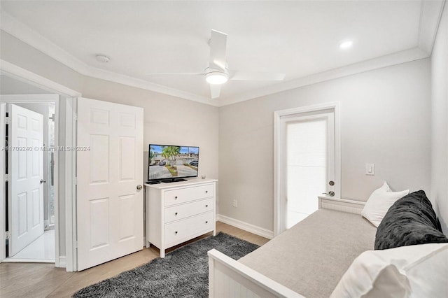 bedroom featuring ceiling fan, wood-type flooring, and crown molding