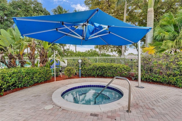 view of swimming pool with an in ground hot tub