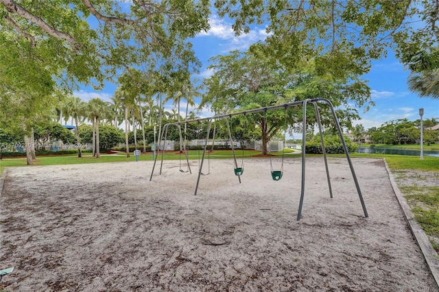 view of property's community featuring a playground and a water view