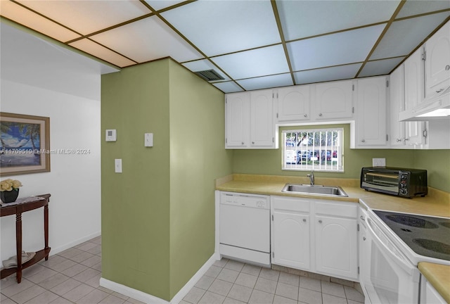 kitchen featuring dishwasher, light tile patterned floors, white cabinets, and sink