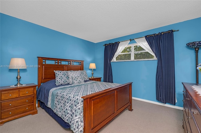 carpeted bedroom featuring a textured ceiling