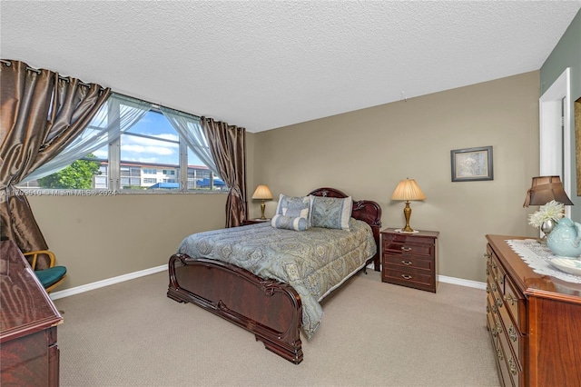 bedroom featuring a textured ceiling and light carpet