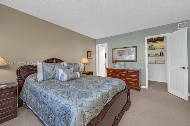 carpeted bedroom with a textured ceiling