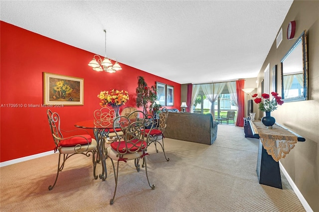 dining room featuring a textured ceiling and light carpet