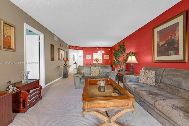 carpeted living room featuring a chandelier and a textured ceiling