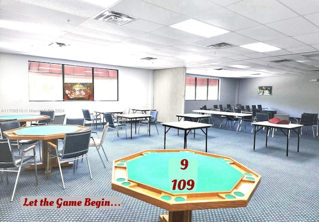 game room featuring carpet flooring and a drop ceiling