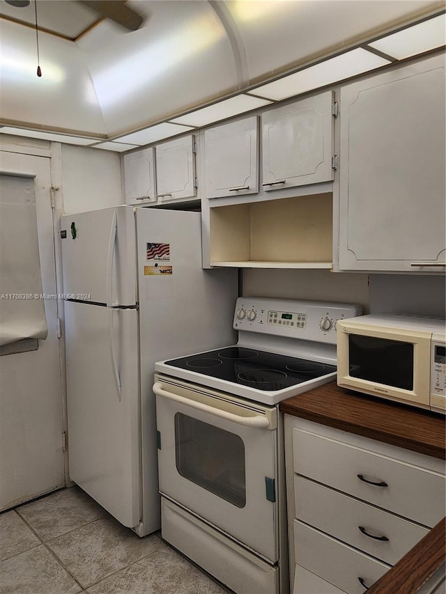 kitchen featuring white cabinets and white appliances