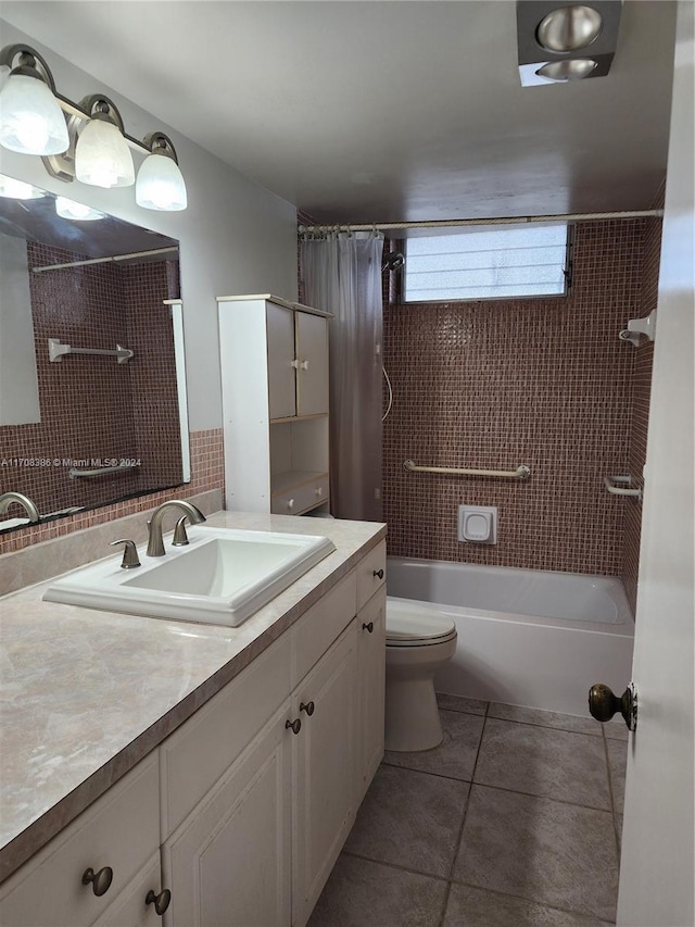 full bathroom featuring tile patterned flooring, vanity, toilet, and shower / tub combo with curtain