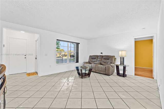 tiled living room featuring a textured ceiling