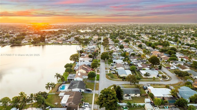 aerial view at dusk with a water view