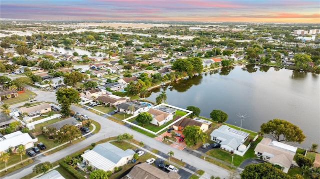 aerial view at dusk with a water view