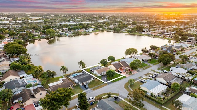 aerial view at dusk with a water view