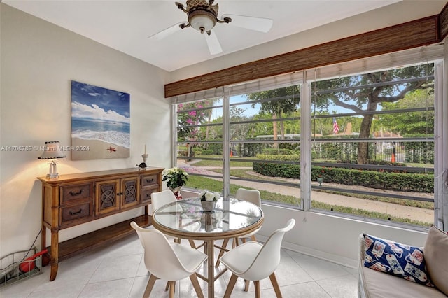 sunroom featuring ceiling fan and a wealth of natural light