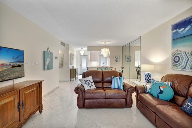 living room with light tile patterned floors and a notable chandelier