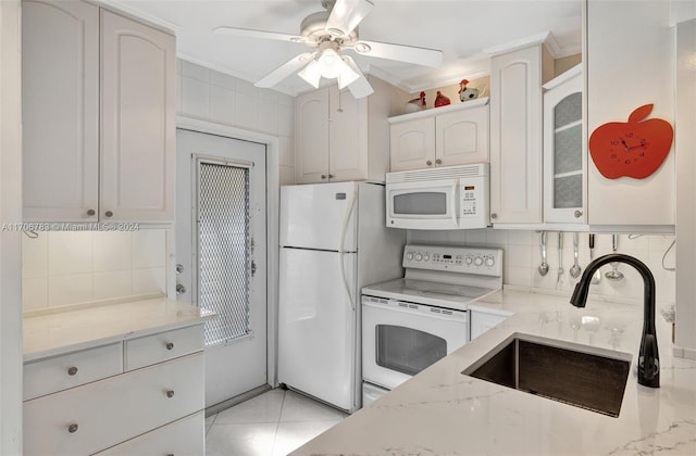 kitchen with white cabinetry, sink, white appliances, and ornamental molding