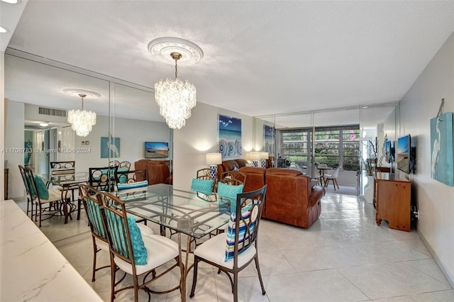 tiled dining area with a chandelier and a textured ceiling