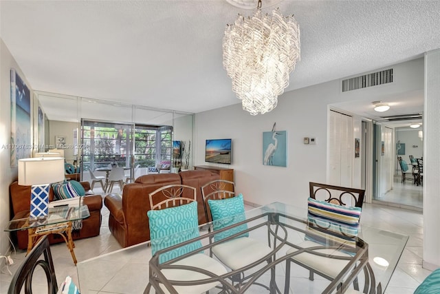 tiled dining space featuring a textured ceiling and a notable chandelier