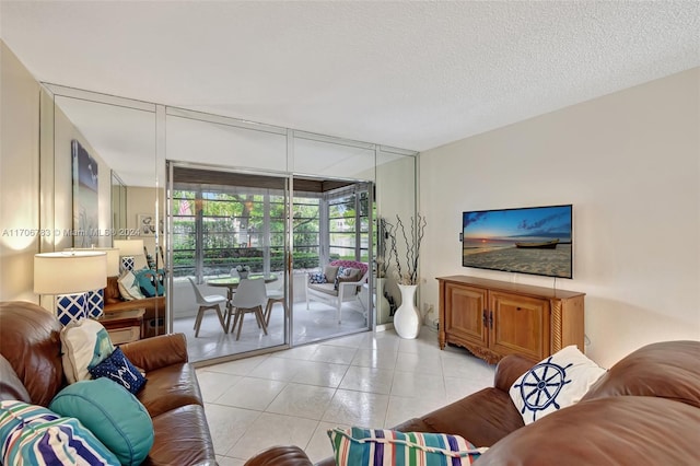 living room featuring light tile patterned flooring and a textured ceiling