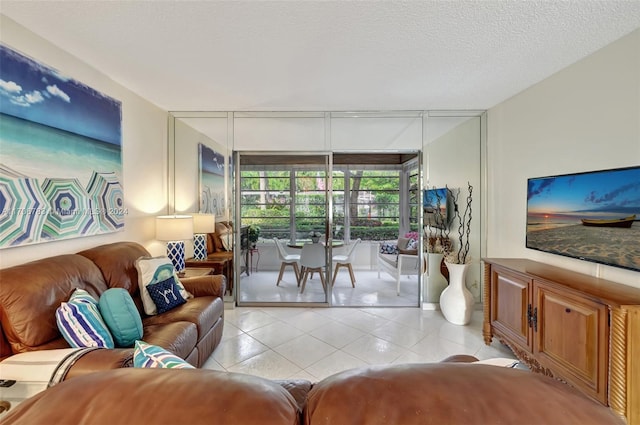 tiled living room featuring a textured ceiling